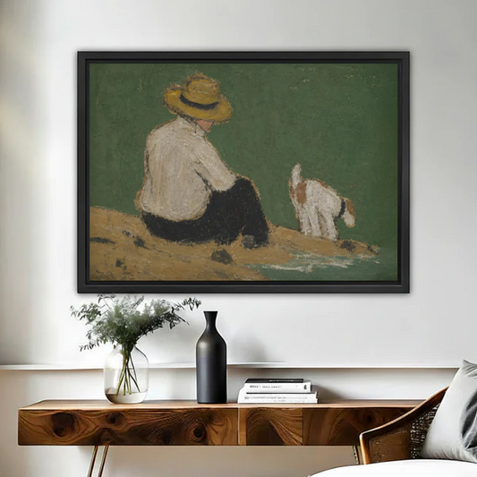 Vintage oil painting style framed wall art of a boy in a straw hat sitting beside a dog near the water, hung above a wooden console table