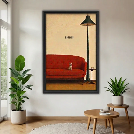 Black-framed vintage dog red sofa canvas wall art with “Big Plans” lettering displayed between houseplants.