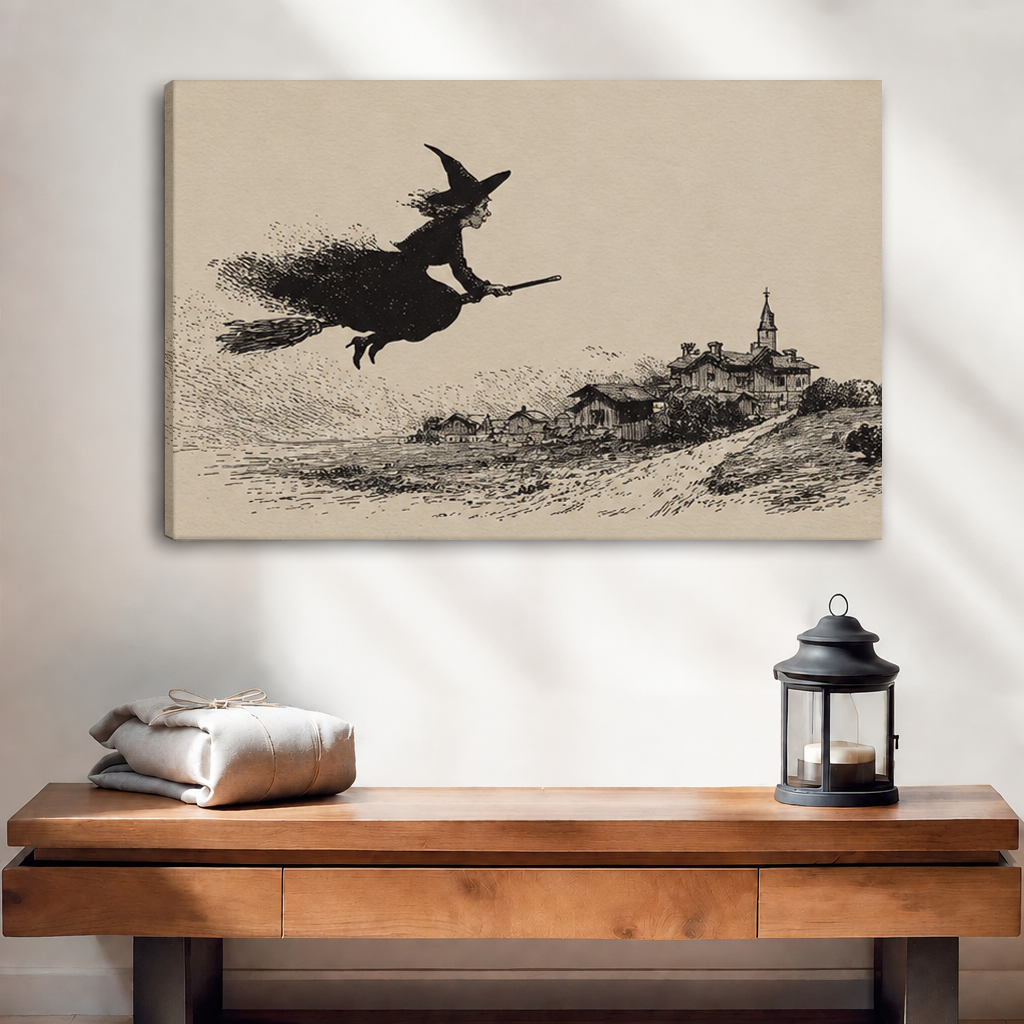 Unframed vintage flying witch canvas wall art above a wooden console with folded linens and a black lantern.