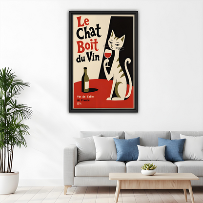 Woman holding framed vintage French cat wine canvas wall art, showing the playful bistro poster at full scale.