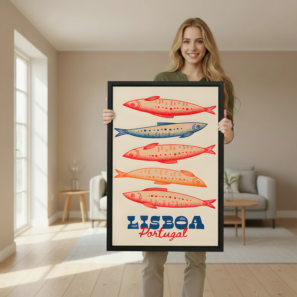 Woman holding a large framed vintage Lisboa Portugal sardine art print to demonstrate print size in a bright Scandinavian-style interior