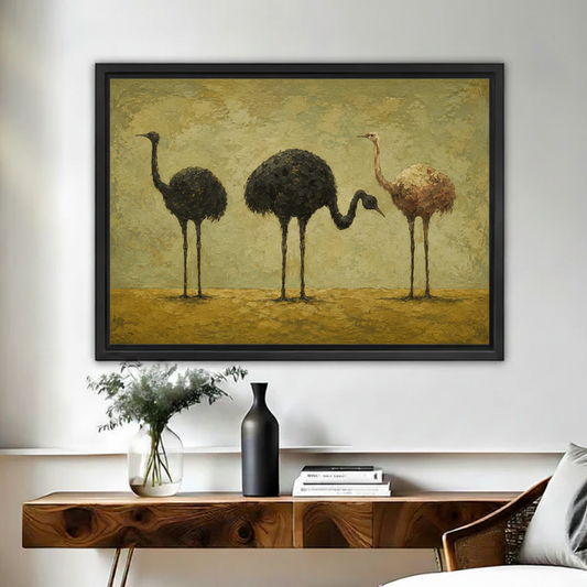 Vintage ostrich trio framed canvas print on a white wall above a wooden sideboard with ceramic vase and eucalyptus in a cozy living room