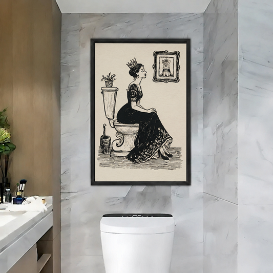 Vintage queen on toilet canvas wall art in a black frame above a white toilet in a marble bathroom.