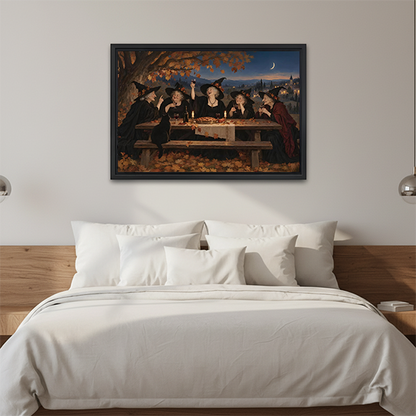 Black-framed witches feast canvas wall art above a wooden console, with a lantern beside folded blankets.