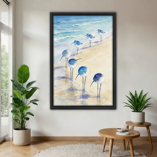 Watercolor beach birds canvas wall art in black floating frame on white wall with monstera and fern plants