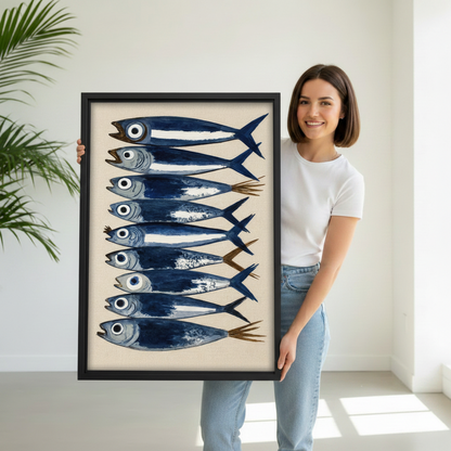 Smiling woman holding large watercolor sardine fish framed canvas wall art showing size in bright white studio
