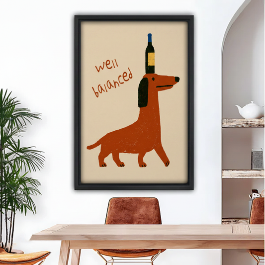 Funny dachshund balancing wine bottle framed wall art above wooden dining table, humorous dog print for kitchen decor