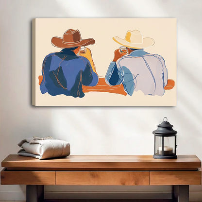 Unframed gallery-wrap western cowboy duo wall art displayed above a wooden bench with folded blankets and a black lantern