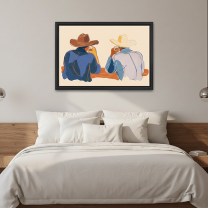 Western cowboy duo wall art in a black frame above white bedding and a wooden headboard.