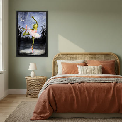 Woman holding framed whimsical ballerina frog canvas wall art in a sunlit room