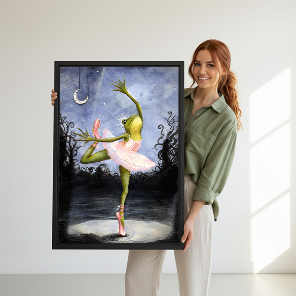Framed whimsical ballerina frog canvas wall art displayed beside green plants in a modern living room