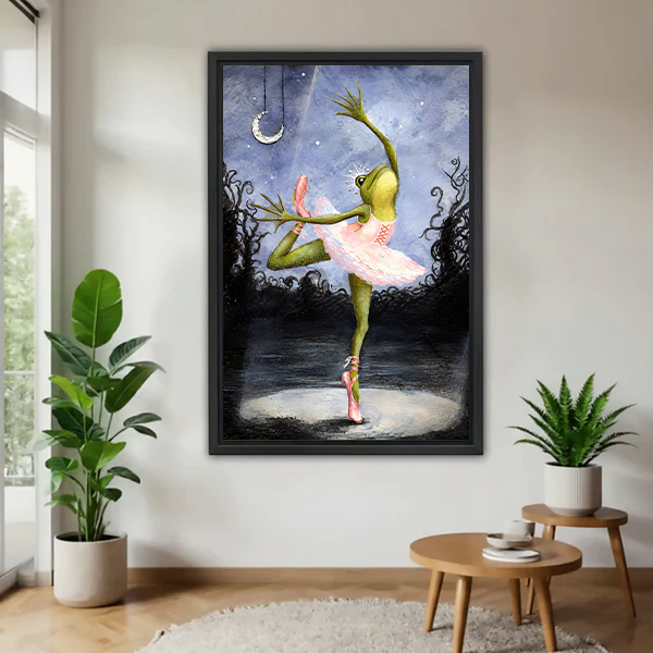Framed whimsical ballerina frog canvas wall art above a neutral living room sofa