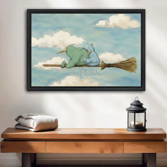 Whimsical watercolor birds on broomstick framed canvas wall art with green and blue birds flying through clouds, displayed above wooden console table with grey linen and black lantern