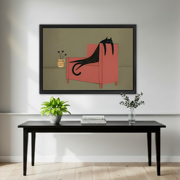 Black-framed whimsical black cat canvas wall art displayed above a black table with plants and stacked books.