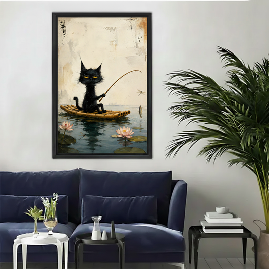 Whimsical black cat fishing on lotus pond framed canvas wall art in black frame above navy sofa in living room