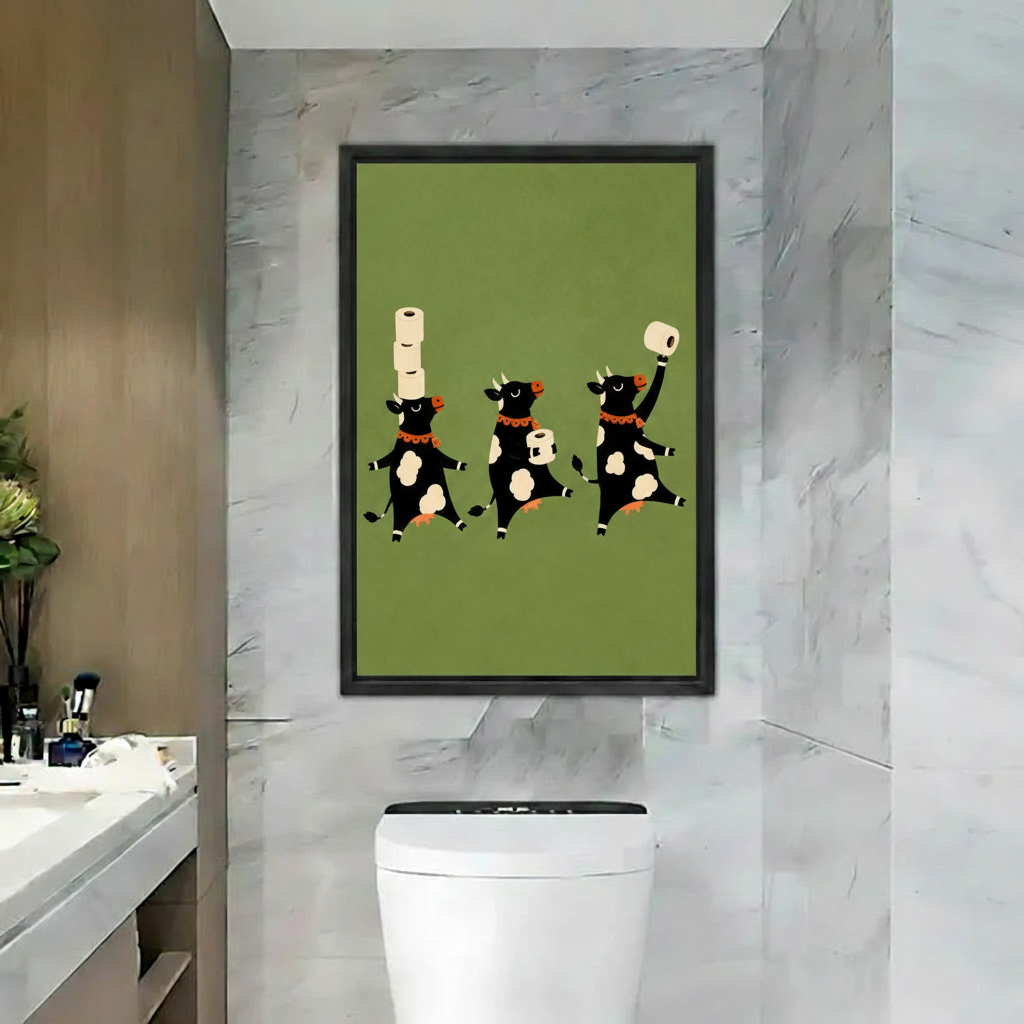 Whimsical black cow bathroom canvas wall art in a black frame, featuring three cows and toilet paper rolls