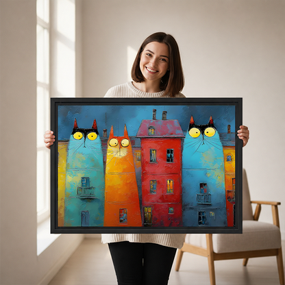 Gallery-wrap whimsical cat buildings canvas wall art featuring yellow-eyed feline facades above a wooden console with folded linens.