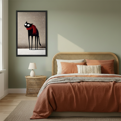 Framed whimsical black cat winter print displayed on sage green bedroom wall above rattan headboard
