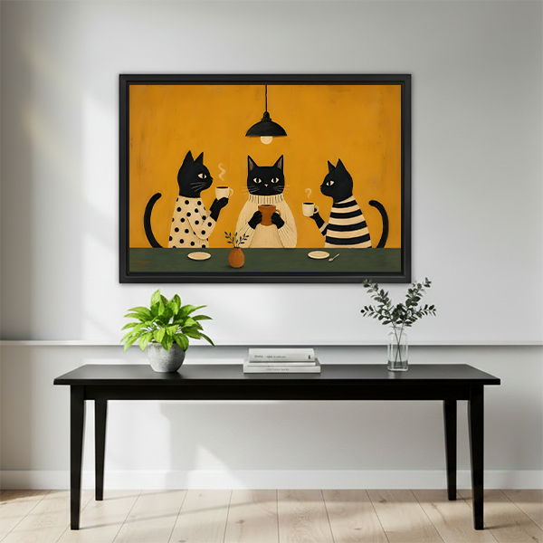 Framed black cats coffee party wall art hung above black console table in bright minimalist entryway with wood floor