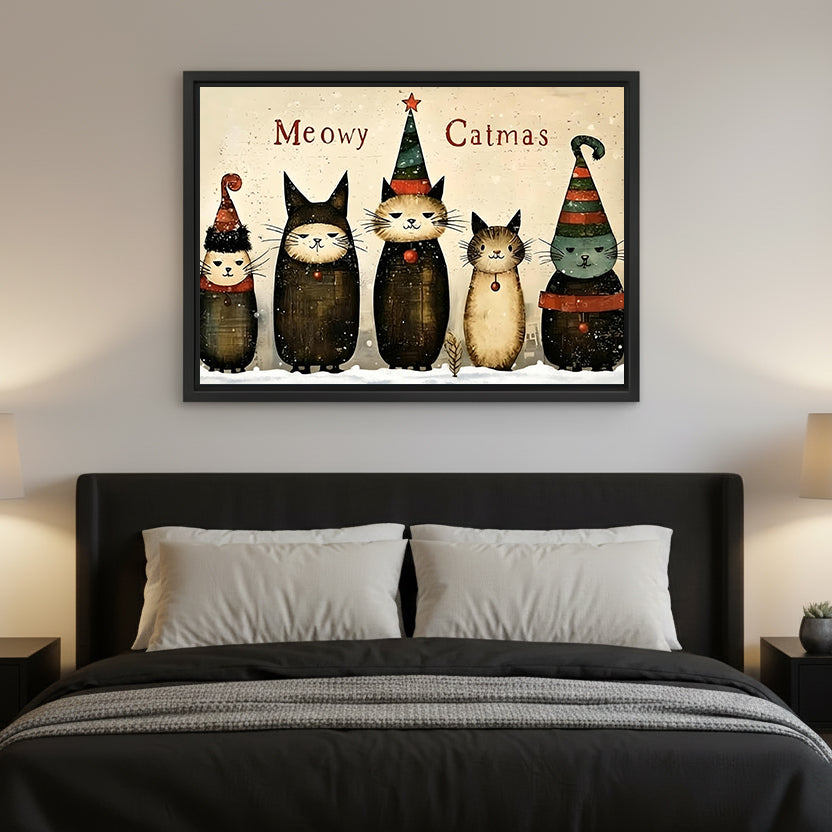 Christmas cats canvas wall art hanging above a black upholstered bed with white pillows and warm lamps