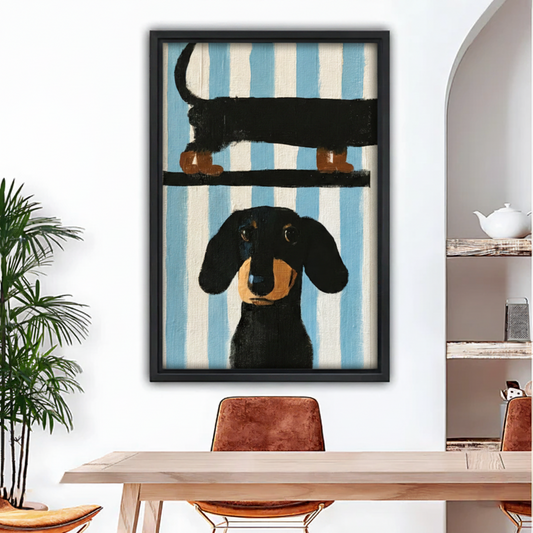 Whimsical dachshund striped framed canvas wall art in black frame hanging above light wood dining table