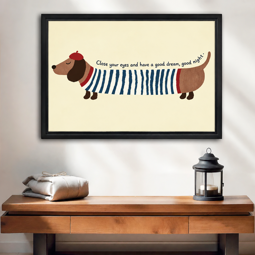 Black-framed whimsical dachshund wall art above a wooden console beside folded linens and a black candle lantern.