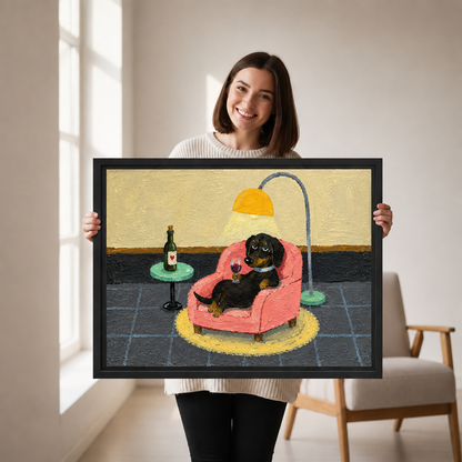Woman holding black-framed whimsical dachshund canvas wall art showing a dog lounging in a pink armchair with wine.