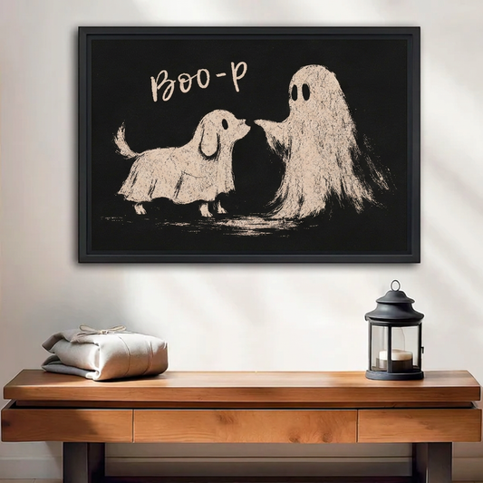 Black-framed whimsical dog ghost canvas wall art displayed above a wooden bench with folded cushions and a lantern.