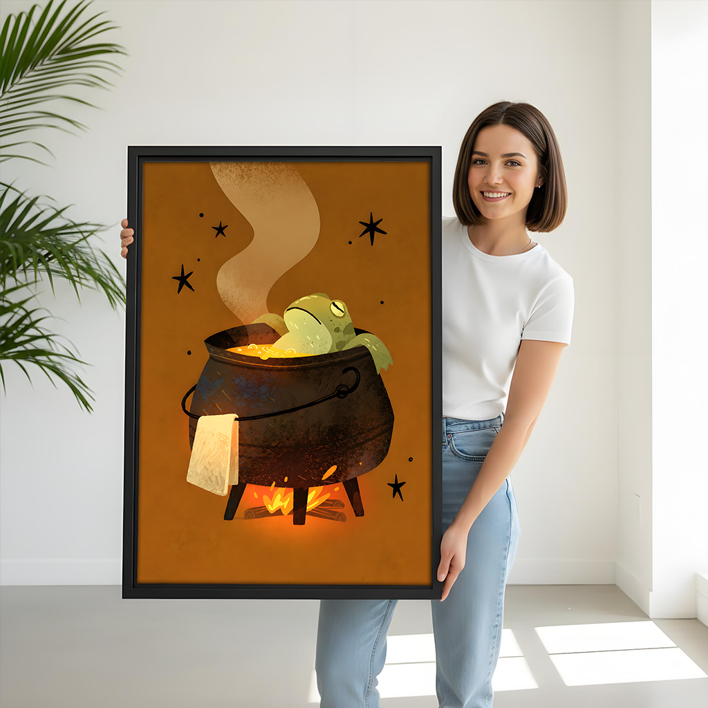 Whimsical frog cauldron canvas wall art held by a smiling woman in a bright room.