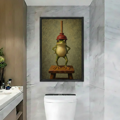 Whimsical frog portrait canvas wall art in a black frame displayed above a bathroom vanity