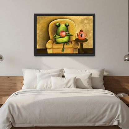 Whimsical frog tea time wall art in a black frame above white bedding and a wooden headboard.