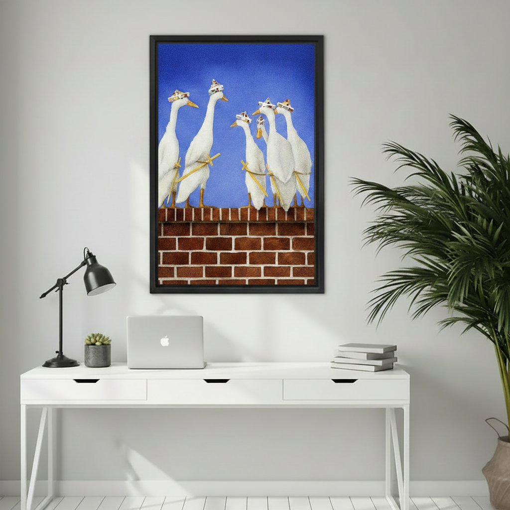 Playful whimsical geese wall art in a black frame above a white minimalist home office desk, featuring white birds with colorful party hats on a brick wall