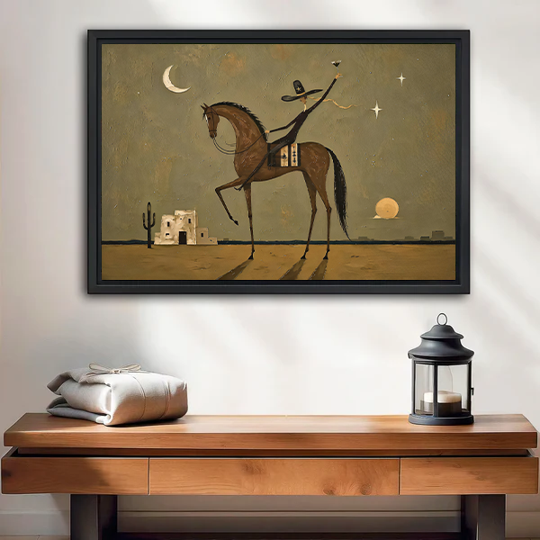 Framed horse rider canvas wall art with a crescent moon displayed above a wooden console and lantern.