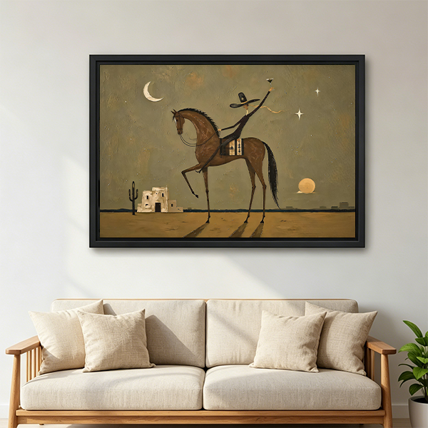 Framed horse rider canvas wall art with a dreamy desert scene displayed above a cream sofa.