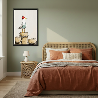 Framed whimsical seagull canvas wall art with a red-hatted bird beside a rattan bed and terracotta bedding.