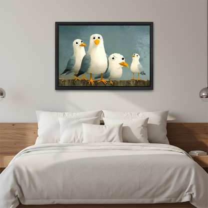 Whimsical seagulls canvas wall art in a black frame above a white bed with a wooden headboard.