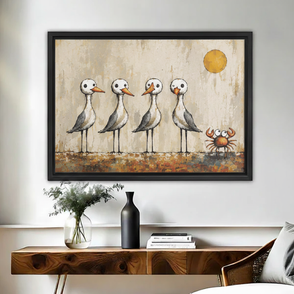 Framed whimsical seagulls and crab wall art hanging above black console table in bright modern entryway