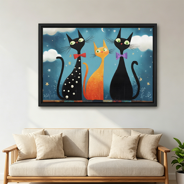 Framed whimsical three cat night canvas wall art hanging above a neatly styled bedroom