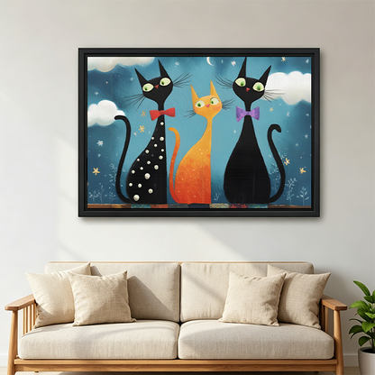 Framed whimsical three cat night canvas wall art hanging above a neatly styled bedroom