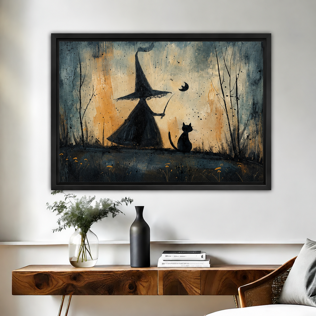 Framed whimsical witch and black cat canvas wall art displayed above a wooden console table