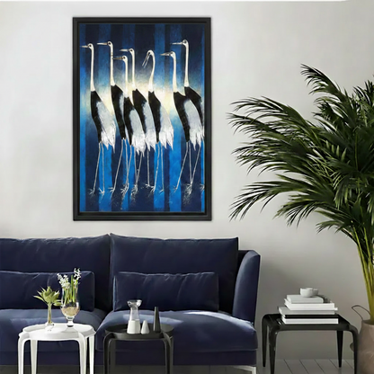 Elegant oil painting framed canvas of a group of white cranes standing in a glowing blue light, displayed above a navy blue velvet sofa in a modern living room