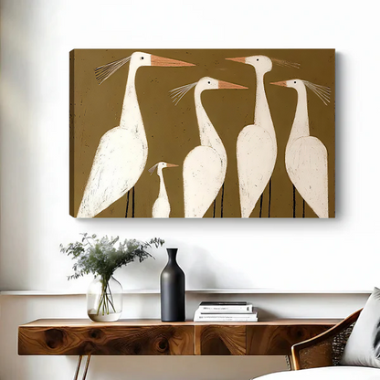 Woman holding black-framed white egrets canvas wall art featuring five cream-colored birds with peach beaks and slender legs.
