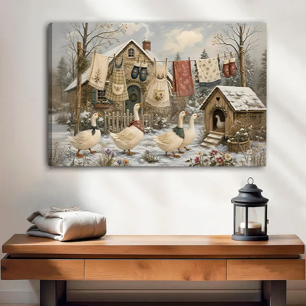 Gallery-wrap winter geese canvas wall art displayed above a wooden console with folded fabric and a black lantern.