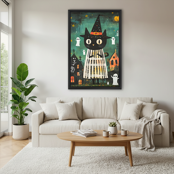 Framed witch cat canvas wall art on a sage bedroom wall above a rattan bed with terracotta linens