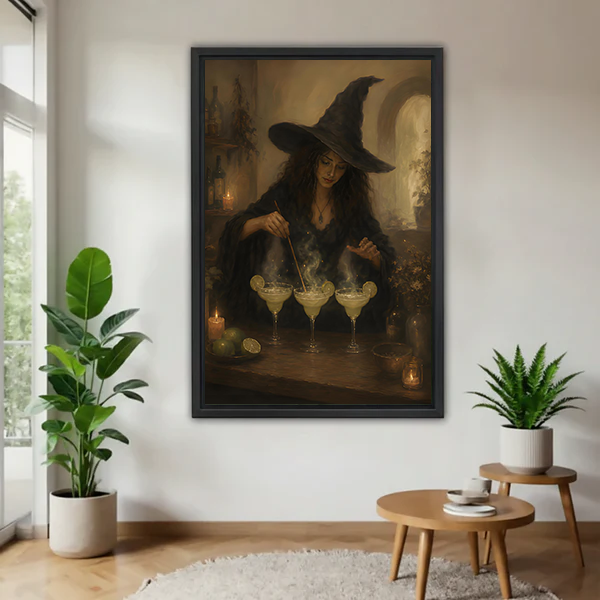 Framed dark academia witch cocktail canvas wall art on a white wall beside tall plants and a round table