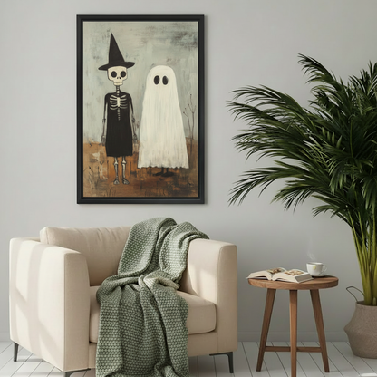 Framed witch and ghost Halloween canvas wall art displayed above a cozy cream reading chair.