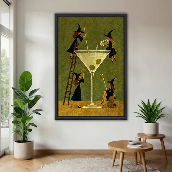 Black-framed witches martini canvas wall art on a white wall beside plants