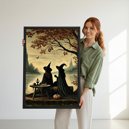 Vintage gothic witches tea party canvas wall art in a black frame, displayed between leafy houseplants.