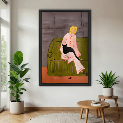 Modern woman with black cat canvas wall art in a black frame above a cream living room sofa.