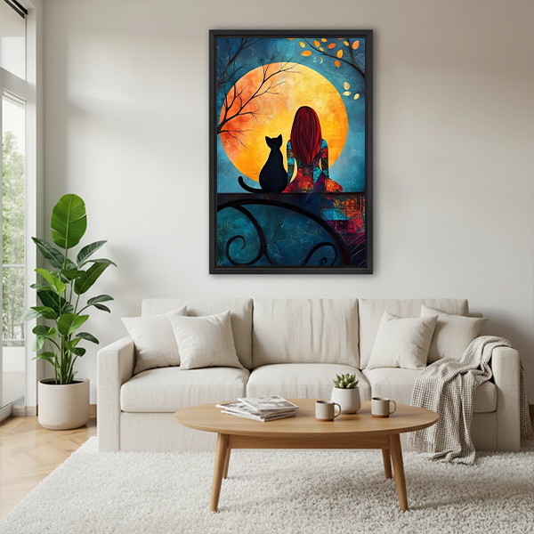Framed woman and black cat moon canvas wall art with a golden moon hanging above a cream sofa.